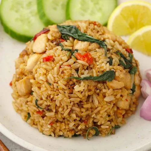 Khao Pad Ka Phao (Basil Fried Rice) — Stir-fried egg, meat, garlic, fresh chili, onion, green beans, rice, sweet pepper and Thai basil leaves.
