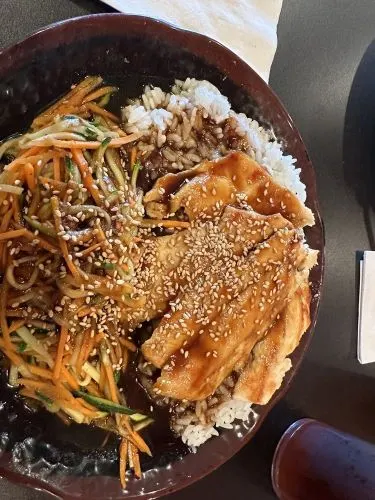 Chicken Teriyaki — Grilled chicken breast with teriyaki sauce, served with stir-fried vegetables and steamed Japanese rice.