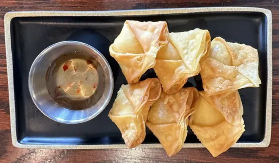 Crab Puffs — Seasoned crabstick and cream cheese filling wrapped in wonton skin and deep fried, served with sweet and tangy chili sauce.