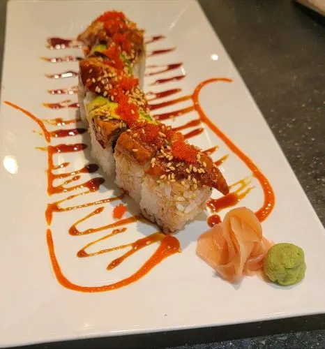Dragon Roll — Shrimp tempura roll, with eel, avocado and masago on top.