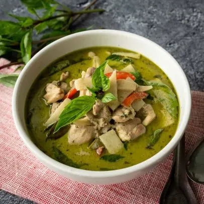 Kaeng Keaw Wan (Thai Green Curry) — Green curry paste, coconut milk, Thai eggplant, bamboo shoots and fresh basil leaves.