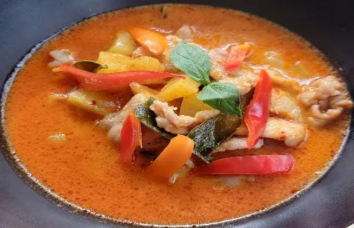 Kaeng Sap-pa-rod (Pineapple Curry) — Red curry paste, coconut milk, fresh pineapple, kaffir lime leaves, and julienned sweet pepper.
