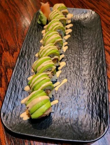 New York Roll — Spicy tuna and tempura flake roll with avocado on top.