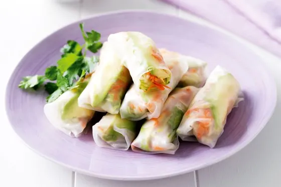 Porpia Lui Suan (Fresh Vegetable Rice Wraps) — Mixed ground pork, carrots, shiitake mushrooms, and green leaf lettuce rolled in rice wrap, and served with homemade sauce.