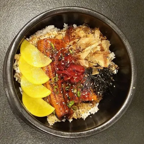 Unagi Don — Barbecued eel and sauce on top of a bowl of rice.